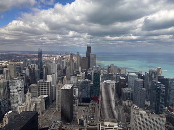 A city skyline and lakefront seen from a high floor