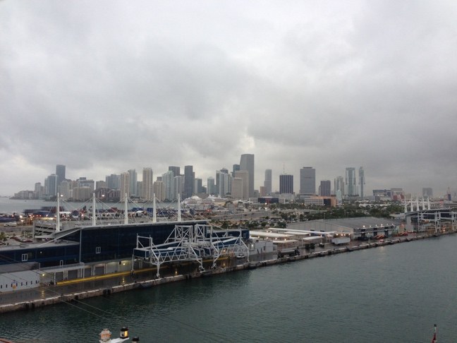 A port and downtown skyline under overcast skies