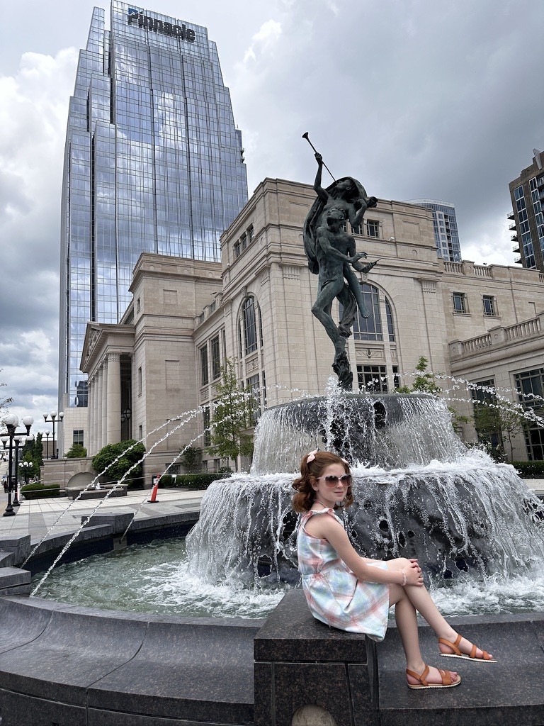 The same fountain, two kids, a day and a night.