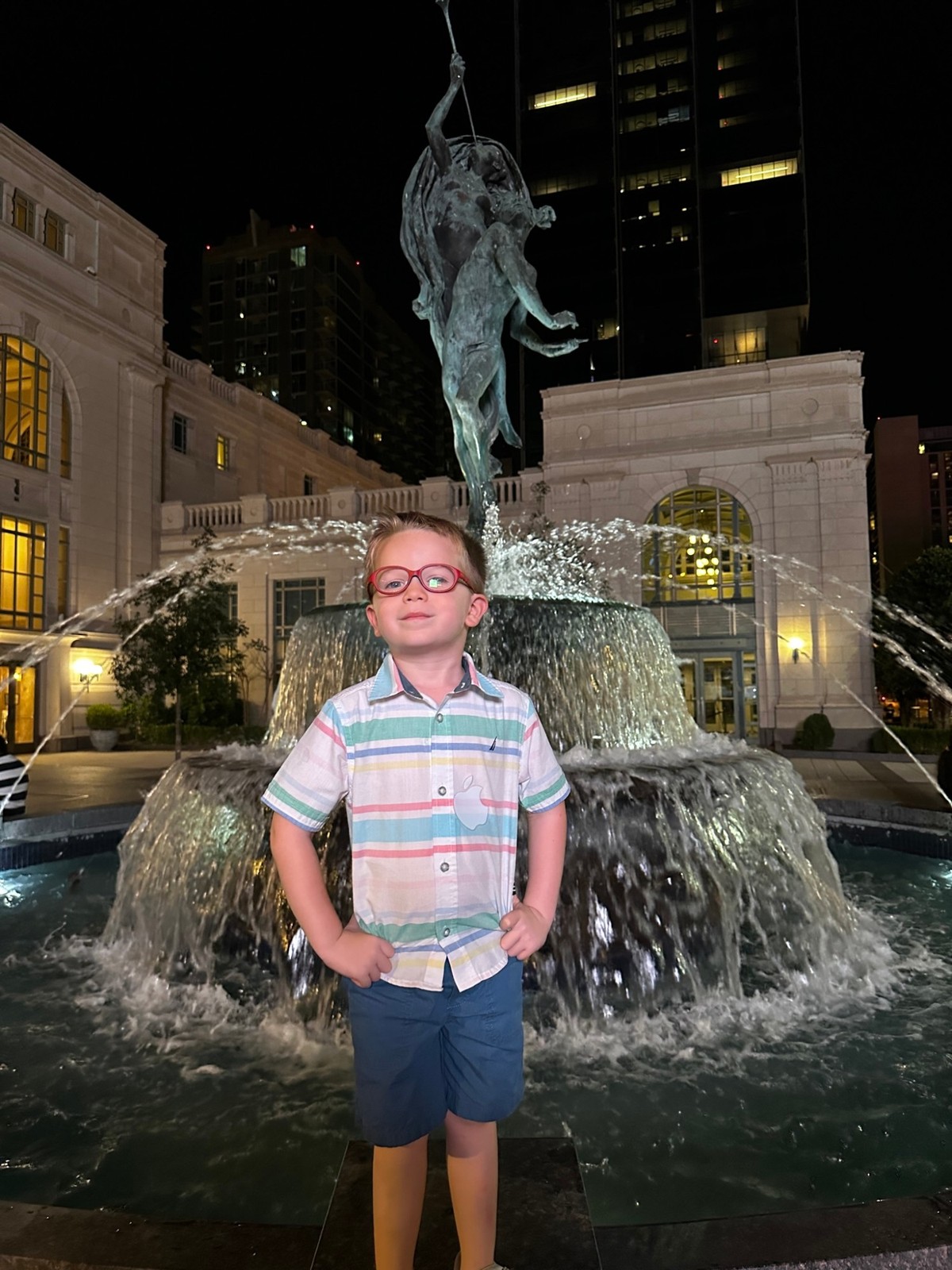 The same fountain, two kids, a day and a night.